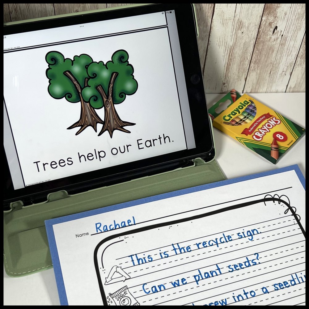A tablet showing a tree and the sentence Trees help our Earth, next to a handwritten Earth Day writing page